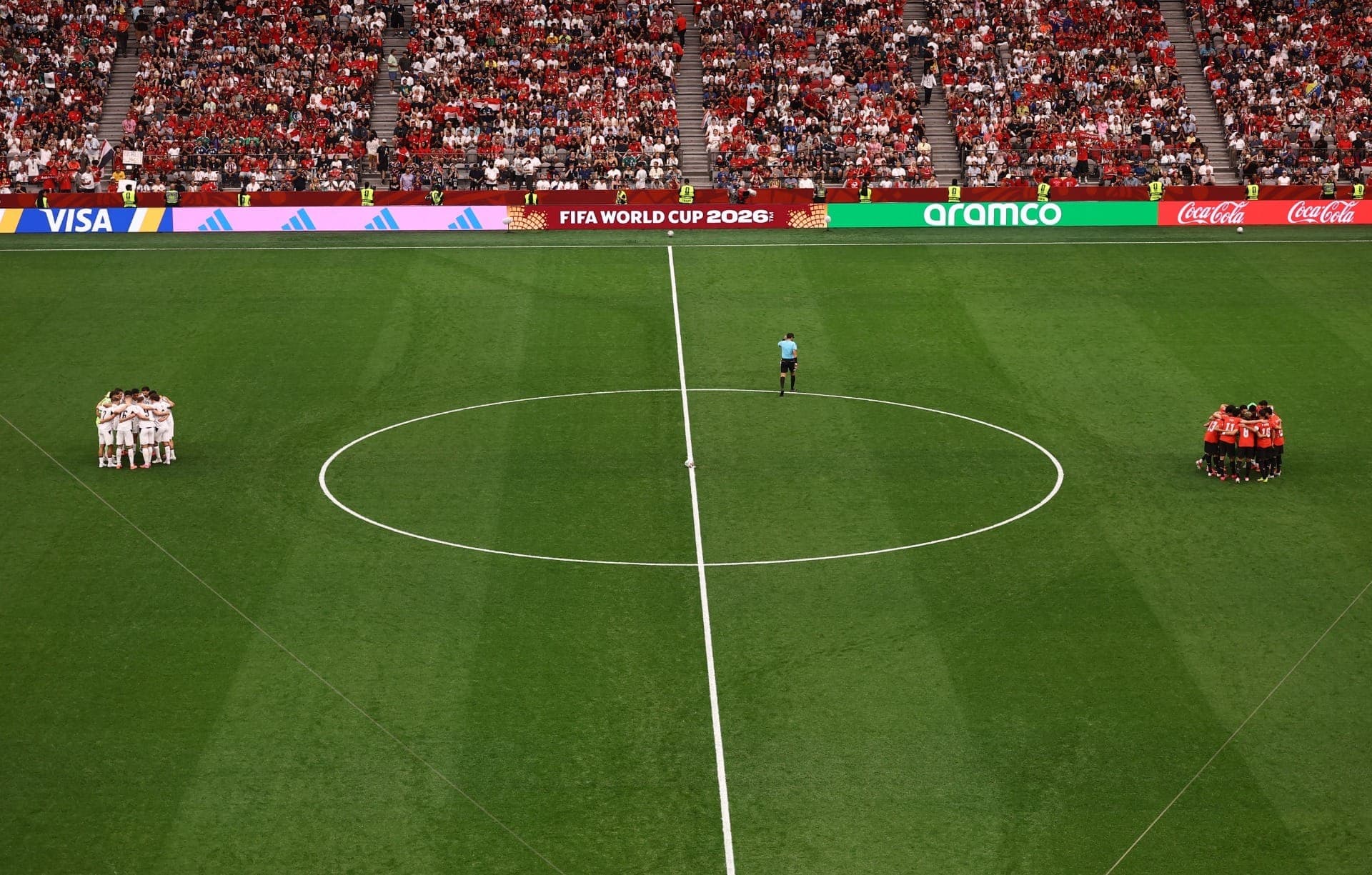 As equipes da Nova Zelândia e do Egito se reúnem em seus respectivos campos antes da partida.